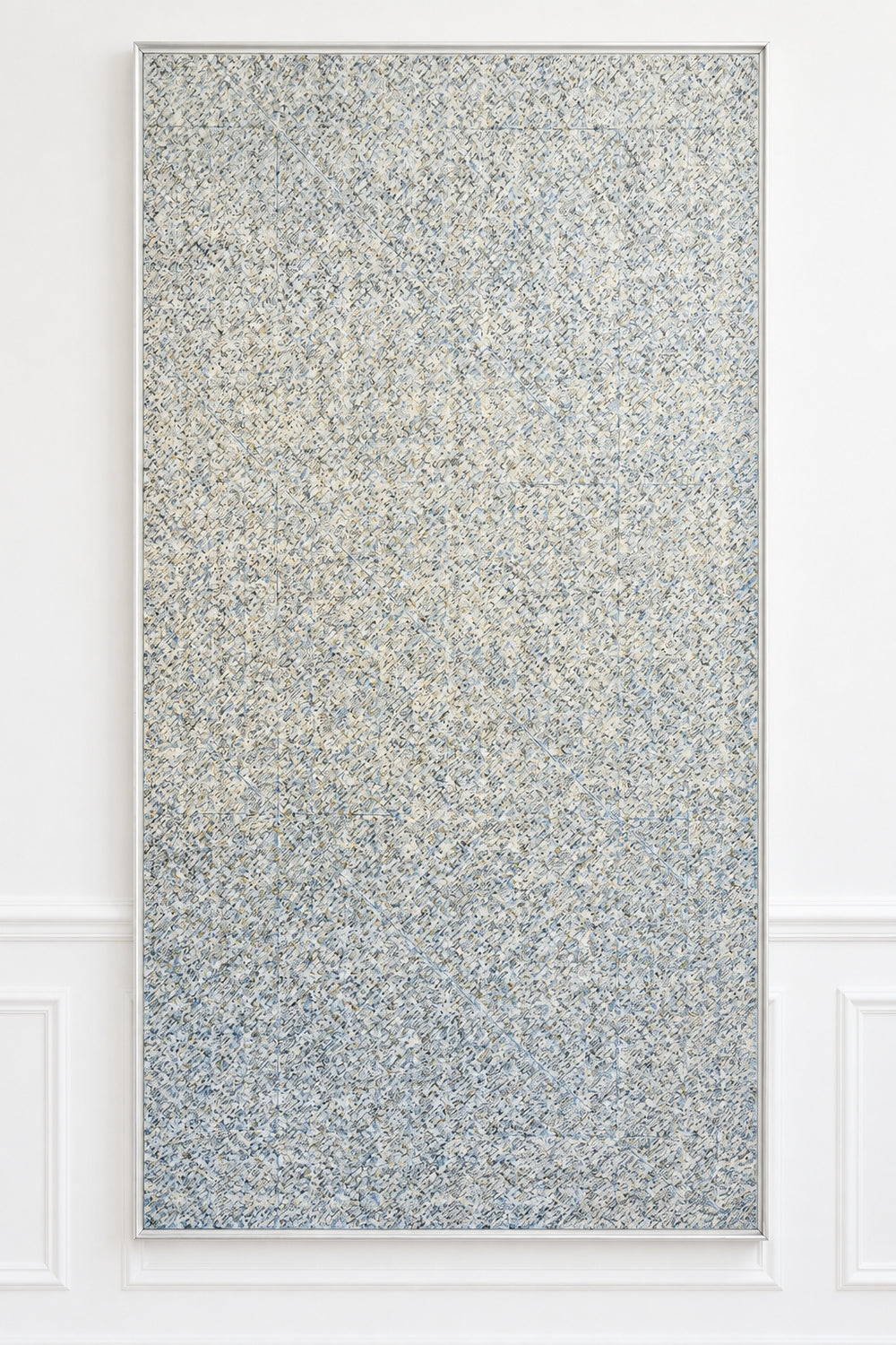 A large rectangular wall panel with a dense speckled pattern in gray, beige, and white, mounted on a white paneled wall.